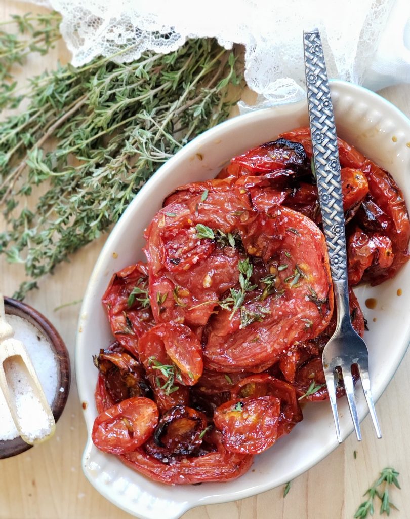 Slow Roasted Balsamic Tomatoes have an intense savory-sweet flavor and caramalized texture and are so delicious on pizza, on salad, in pasta, with proteins (like on steak) or plucked right off the pan!