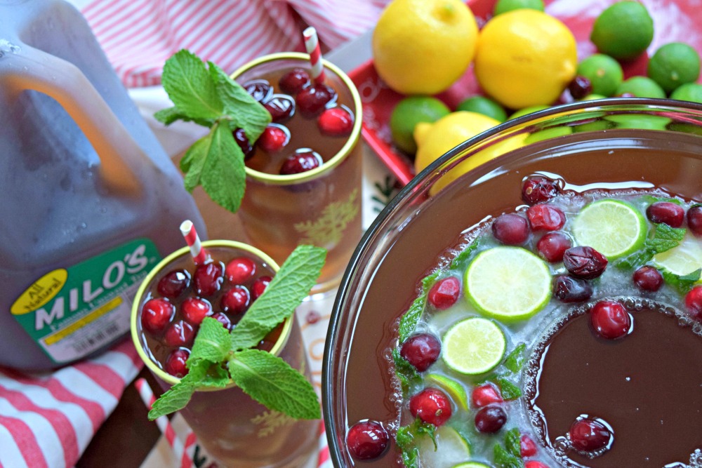 Citrus Cranberry Tea with Holiday Ice Ring is a festive addition to your holiday celebration. A non alcoholic libation that's suitable for the entire family. Three ingredient punch an super easy to make ice ring with lemonade, ginger ale, lemons, limes, cranberries and mint.