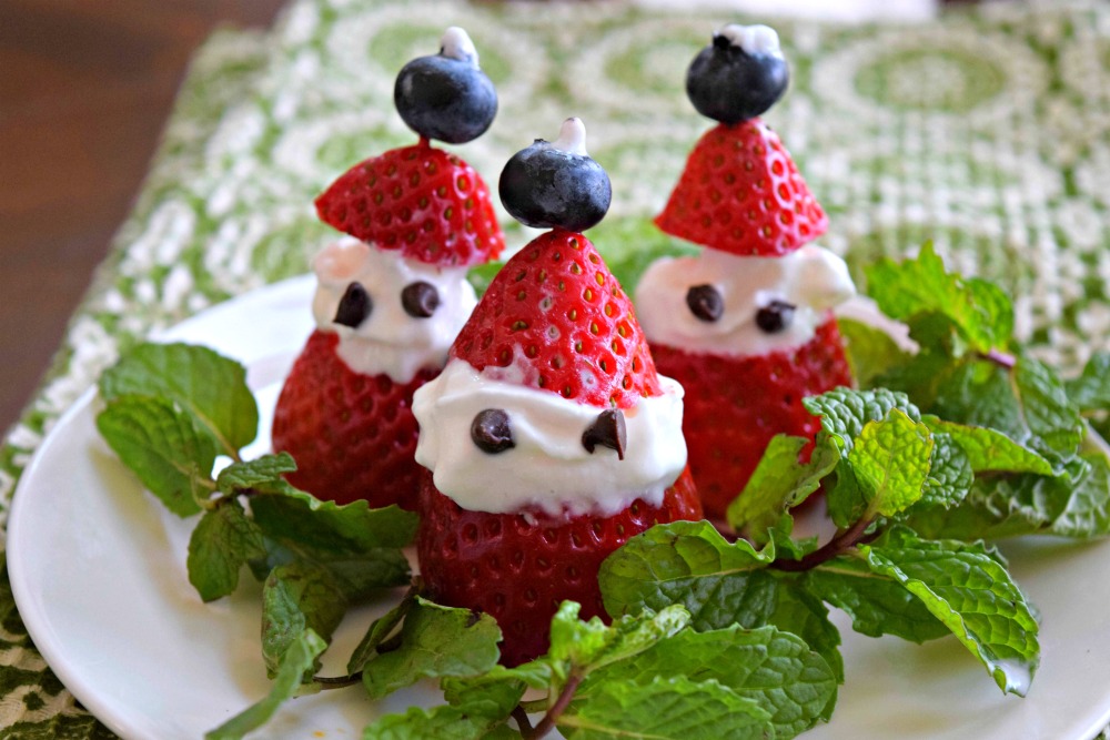 Strawberry Santas are a cute idea for a healthy holiday treat. Young and old alike will love this family friendly, healthy, Christmas dessert. Fruit Ideas for Christmas