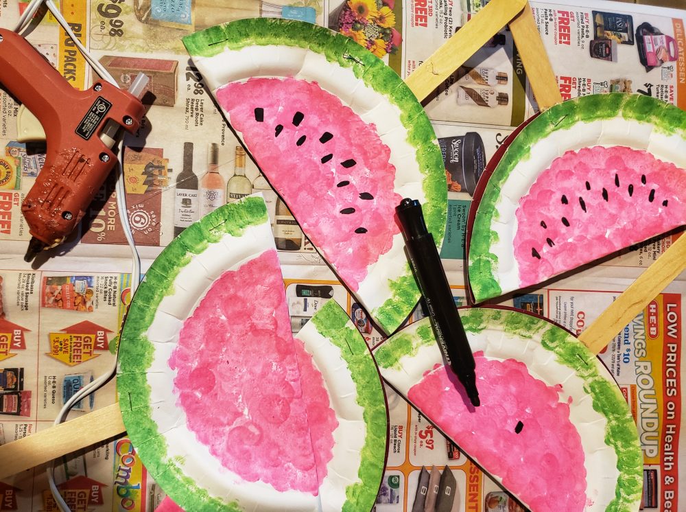 Paper plates made into watermelon-inspired fans for summer!