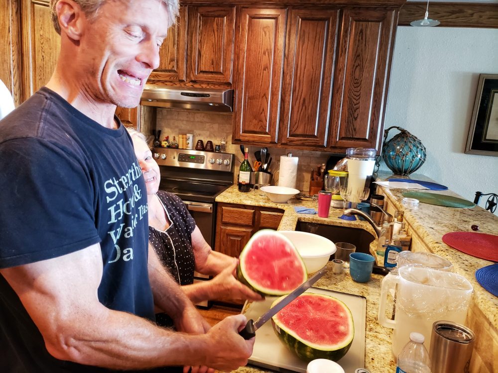 man slicing watermelon