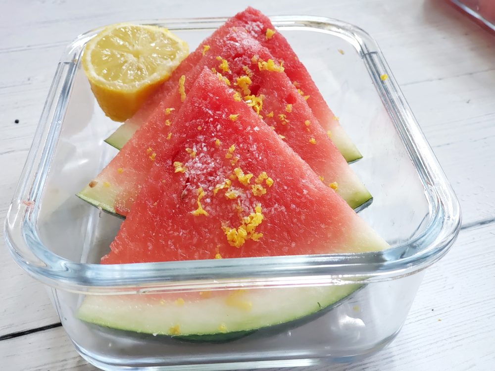 Lemon zest, lemon juice and coarse sea salt on watermelon.