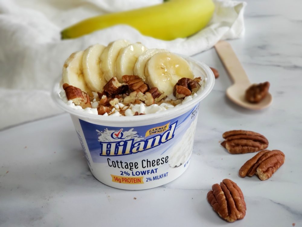 Hiland Dairy 2% Low Fat Cottage Cheese topped with bananas, pecans and maple syrup