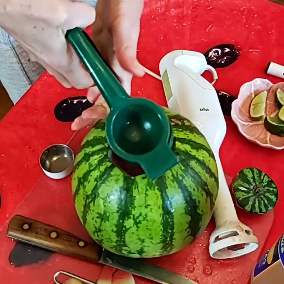 Squeezing Lime Juice into Watermelon Margarita