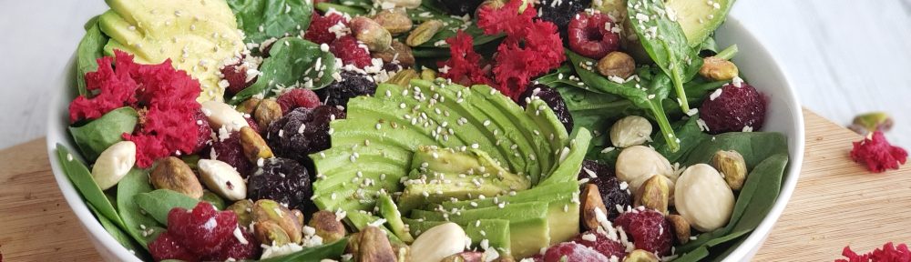 High Fiber Low Carb Salad with avocado, raspberries, blackberries, chia seeds, almonds and pistachios.
