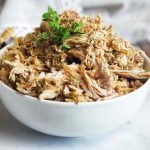 Hatch Green Chile Pulled Pork in Slow cooker -- easy and versatile! Great for tacos, enchiladas, soups and to meal prep and stock pile in the freezer.