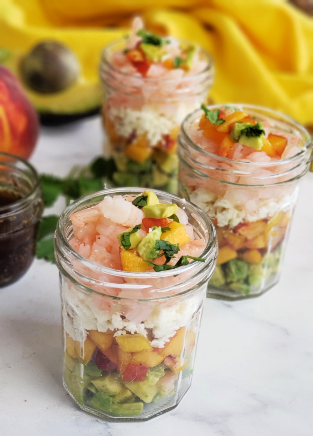 Peach Avocado Shrimp Salad is a refreshing, no-cook lunch or dinner that might remind you of ceviche! Serve in individual jars or ramekins, or stir together gently in a single bowl and serve as an appetizer dip with chips. 