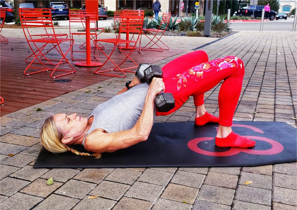 Glute Bridge with Dumb Bells -- how colors can affect your workout and exercise. 