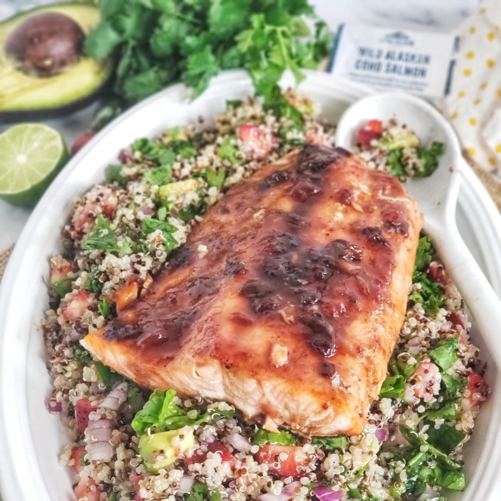 Sweet and lightly spicy, this southwestern inspired strawberry chipotle glazed salmon is delicious and nutritious atop a quinoa salad packed with strawberries, spinach and avocado. Can be made ahead and also great for meal prep. 
