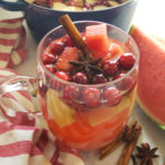 This easy-to-make warm punch featuring watermelon juice is naturally sweet and delicious, bejeweled with fruit and fragrant with seasonal spices. Brandy optional! Perfect for holiday entertaining, including brunches, open houses, cocktail parties and more!