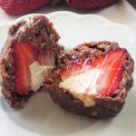 Satisfy your sweet tooth with this single-serve strawberry recipe stuffed with cream cheese and covered in a no-bake chocolate oatmeal cookie. Gluten-free, no added sugar.