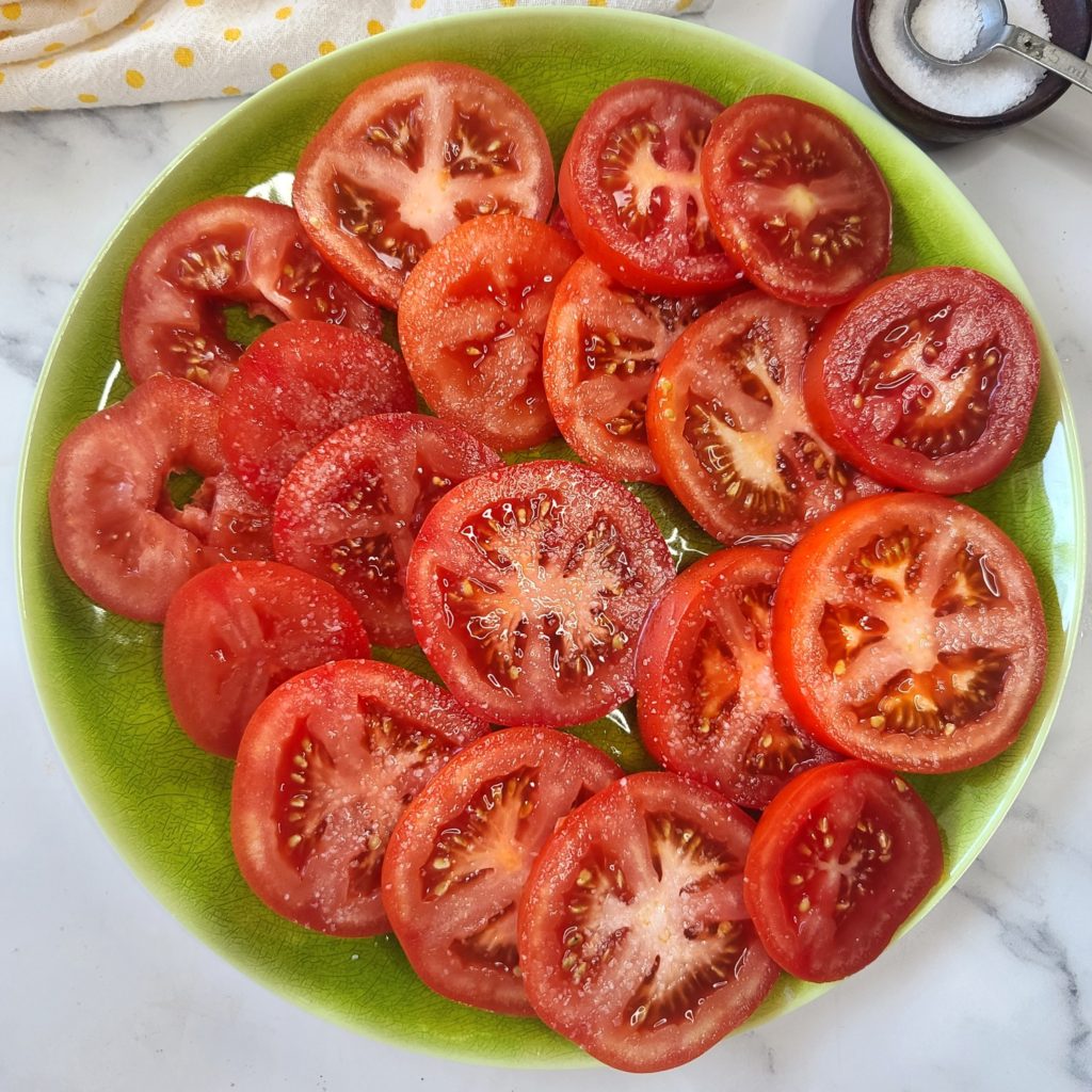 Sweat the tomatoes with a little sale for 30 minutes - this helps remove excess moisture so recipe doesn't get soggy and also intensify flavor. 