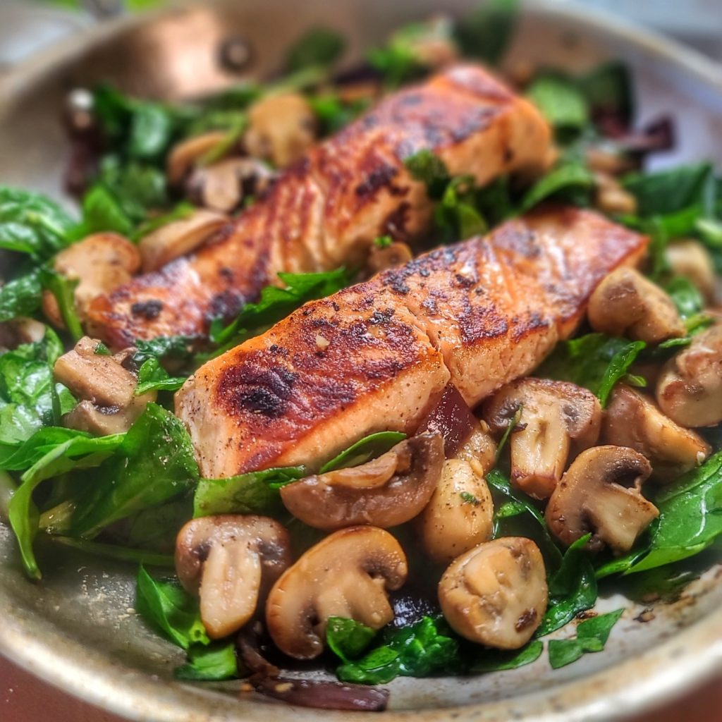 What's better than garlic butter? Garlic butter all over salmon, mushrooms and delicious veggies! This easy one-dish salmon skillet is sure to become your favorite 15-minute meal.