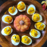 These clever deviled eggs look like little autumn pumpkins, but contain no squash – only eggs, Dijon mustard, salt, pepper and turmeric for the signature orange hue of the season. Low in calories, high in protein – a smart snack for Halloween, Thanksgiving or any fall festival.