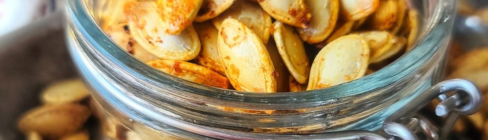 Garlicky Roasted Pumpkin Seeds can be made in the air-fryer or oven and are a quick, easy and economical snack you will love this fall season.