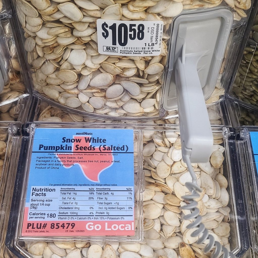 Pumpkin seeds in white shell sold in bulk bin at market