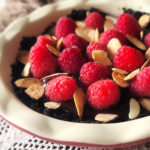 A rich and delicious chocolate tart bejeweled with raspberries and almonds, and perfectly portioned to serve two to four guests. No added sugar and can be gluten-free depending on what type of cookie used for the crumb crust.