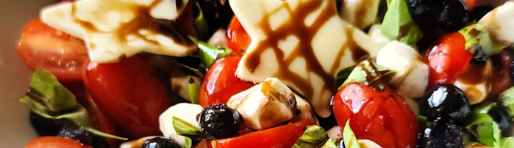 Everyone loves a Caprese salad with juicy tomatoes, aromatic sweet basil and creamy mozzarella cheese all drizzled in balsamic syrup. My patriotic version of the classic favorite summer salad that adds blueberries in honor of the USA and Red, White and Blue. Perfect for summer entertaining.