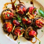 Air fryer Caprese Stuffed Mushrooms are a low carb, 31-calorie, easy appetizer made with mozzarella, tomato, basil, and balsamic glaze in just 15 minutes.